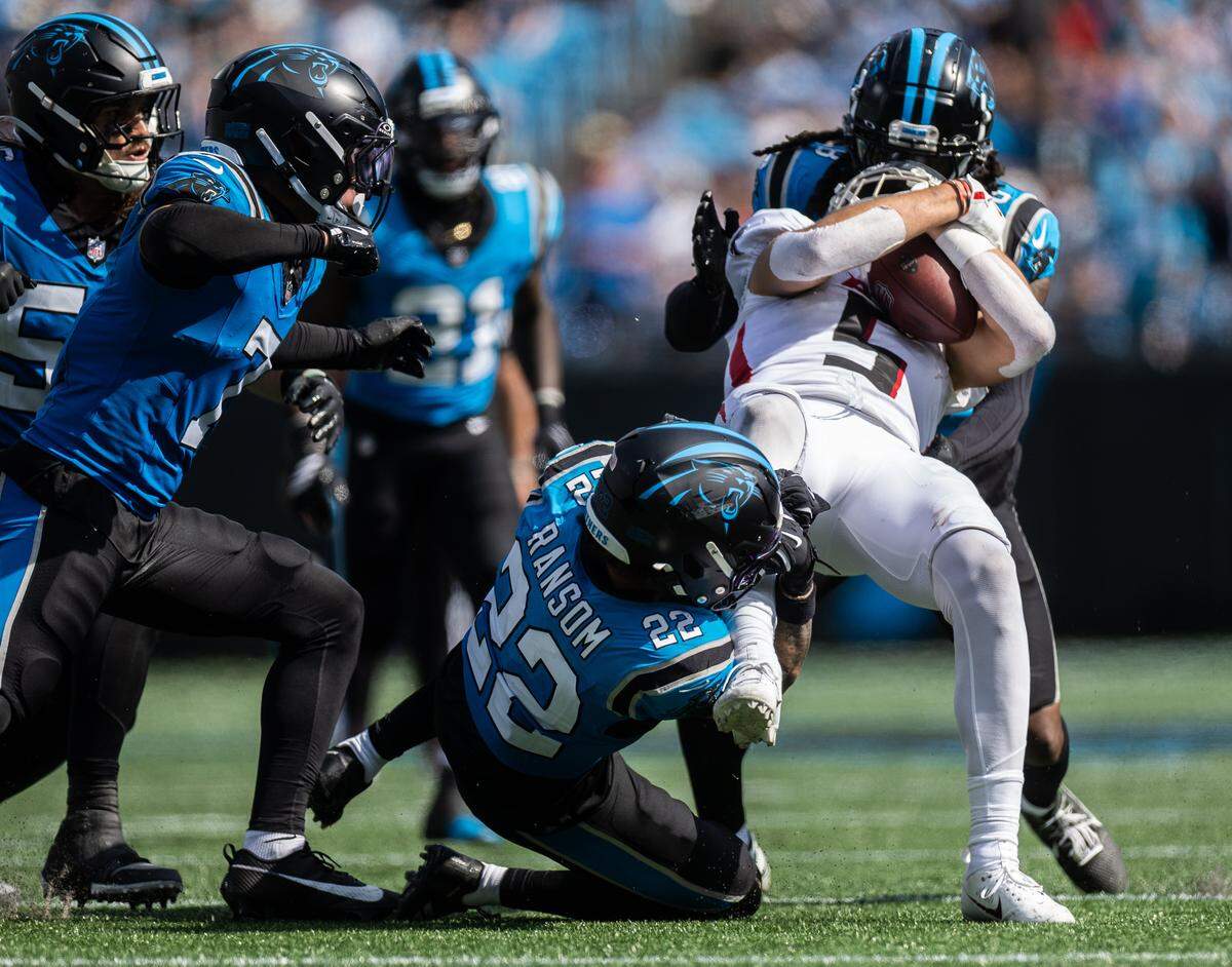 Atlanta Falcons wide receiver Drake London is taken down by a host of Carolina Panthers defenders Sunday at Bank of America Stadium.