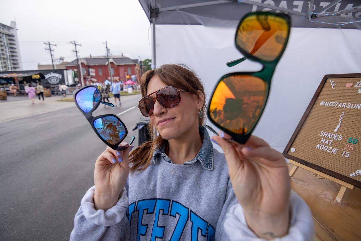 A fan shops the sunglasses at Lovin’ Life Music Fest.