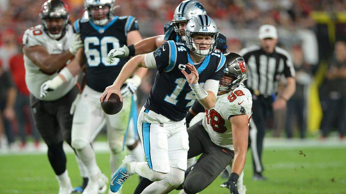 Carolina Panthers quarterback Sam Darnold, shown scrambling against the Tampa Bay Buccaneers at Raymond James Stadium in Tampa, Fla., on Sunday, Jan. 9, 2022, had an uneven first day at minicamp.