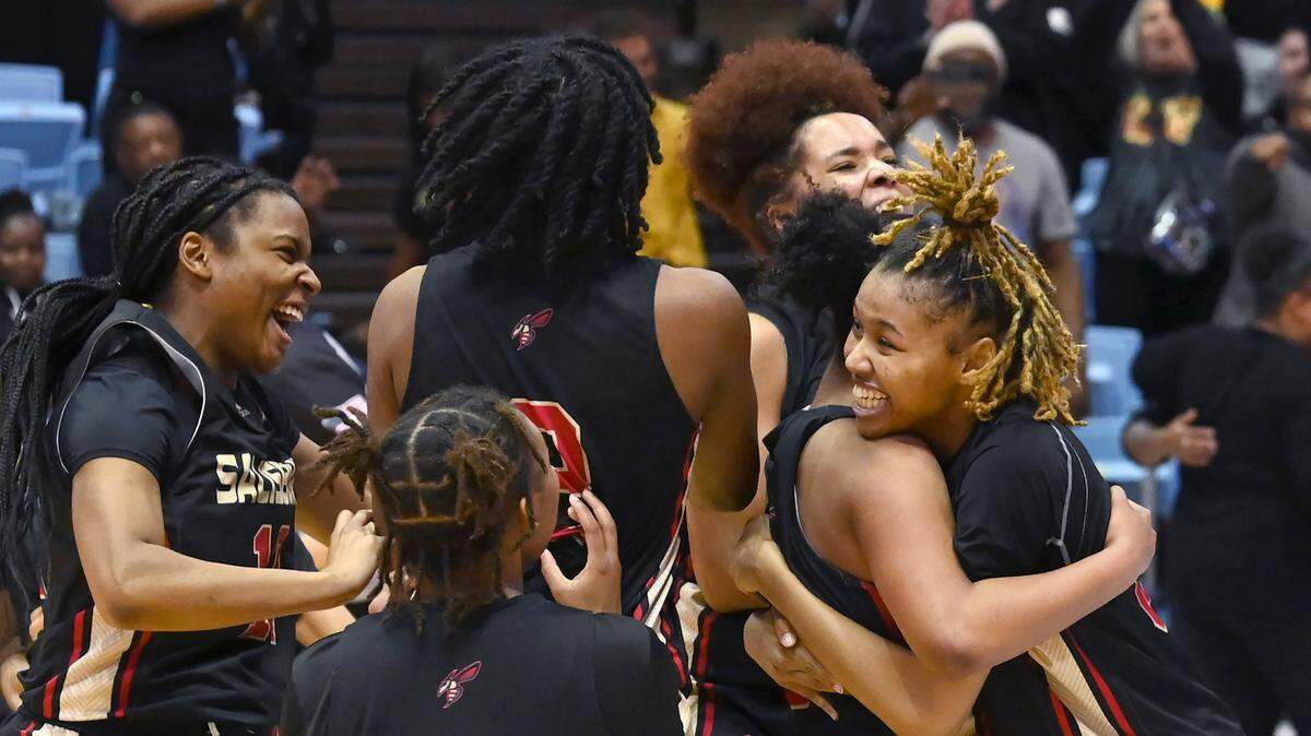 Members of the Salisbury girls basketball team celebrate their 48-39 victory over Seaforth at the Dean Smith Center on Saturday, March 11, 2023.