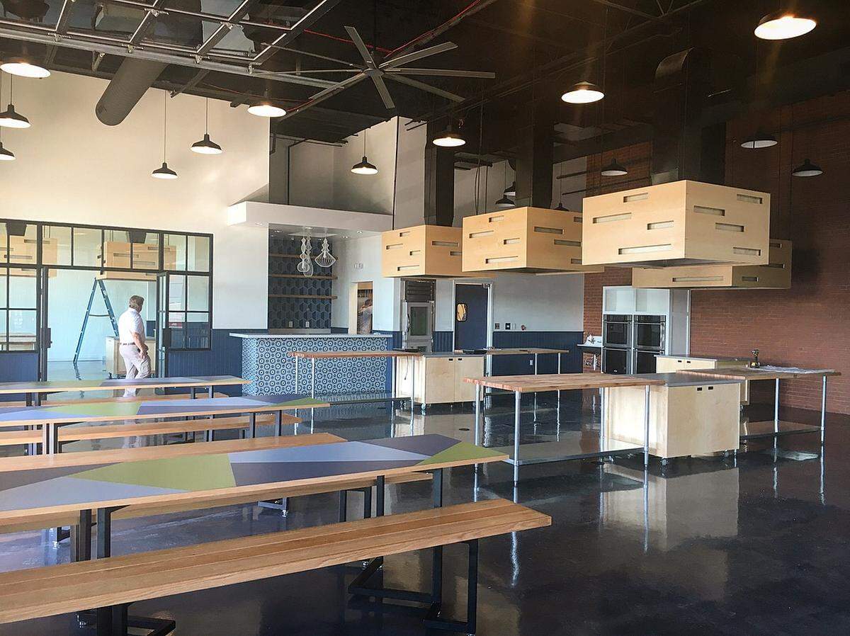The new version of Chef Alyssa’s Kitchen includes two areas for cooking classes and large box-style hoods with lights over the work stations.