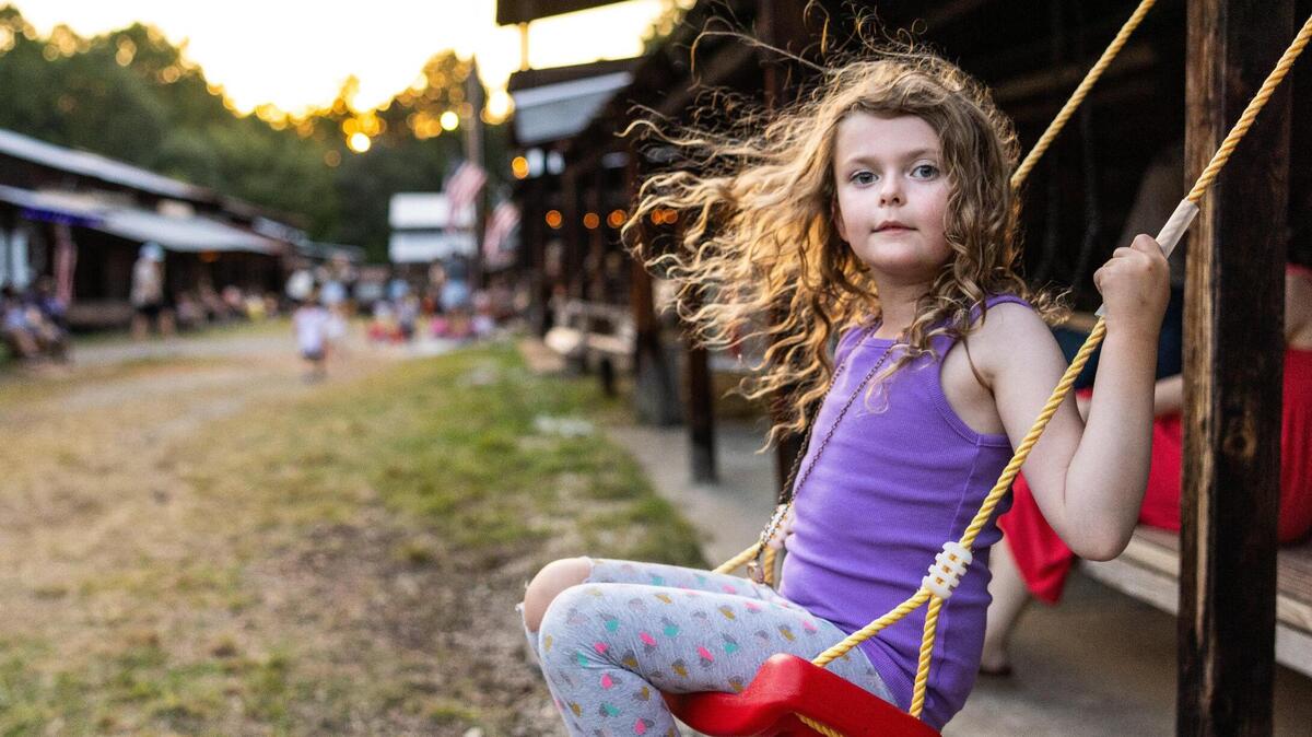 Caroline Craig, 7, swings at Rock Springs Camp Meeting in Denver, N.C., on Friday, August 10, 2023.