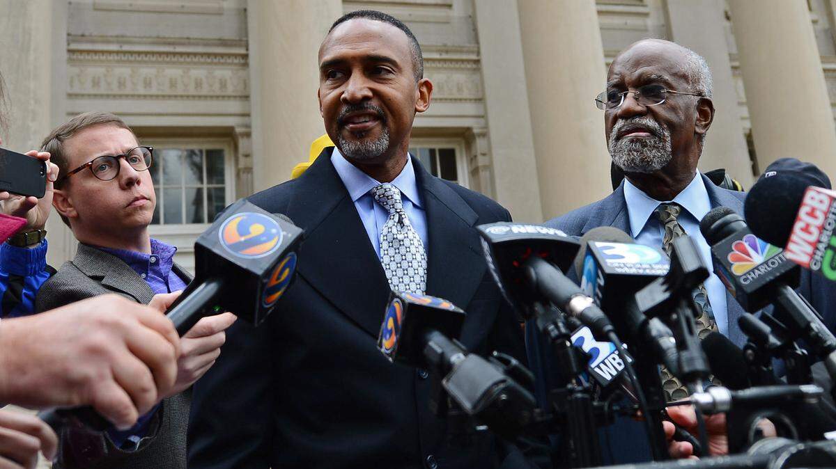 Former Charlotte mayor Patrick Cannon, center, addresses members of the media on casting a ballot in the recent election despite losing his right to vote outside the Federal Courthouse in November 6, 2014.