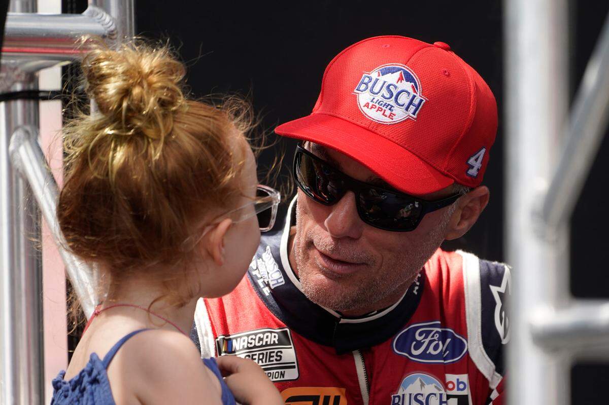 Kevin Harvick talks to his daughter Piper before a NASCAR Cup Series auto race at the Michigan International Speedway in Brooklyn, Mich., Sunday, Aug. 7, 2022. (AP Photo/Paul Sancya)