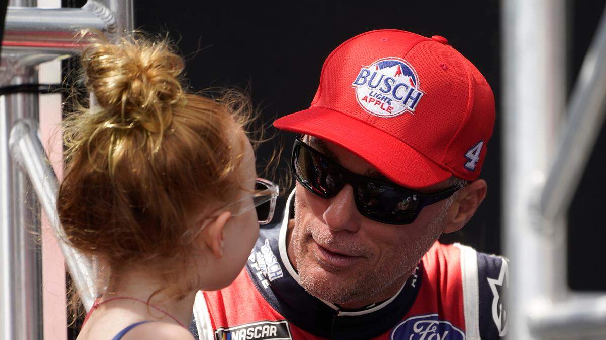 Kevin Harvick talks to his daughter Piper before a NASCAR Cup Series auto race at the Michigan International Speedway in Brooklyn, Mich., Sunday, Aug. 7, 2022. (AP Photo/Paul Sancya)