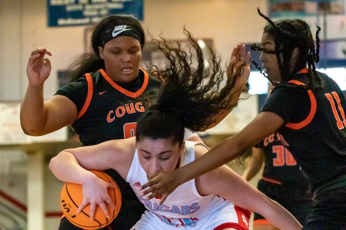 Chambers and Catholic fight for possession of the ball