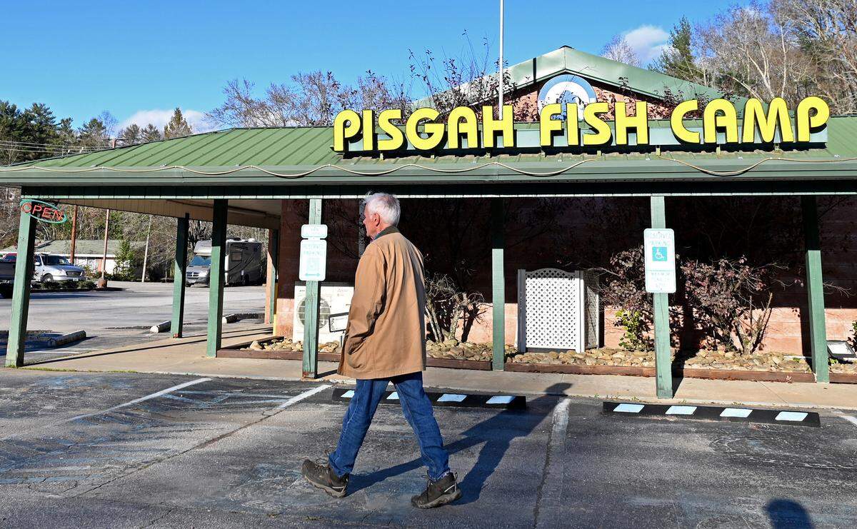 Mike Hawkins walks past the Pisgah Fish Camp Restaurant in Brevard, NC on Friday, November 15, 2024. The restaurant has been in his family for almost 60 years. Rain from Hurricane Helene filled a creek near the restaurant causing water to rise three-feet. With three-feet of water inside the restaurant the walls, wiring and cooking equipment were damaged. The restaurant remains closed.