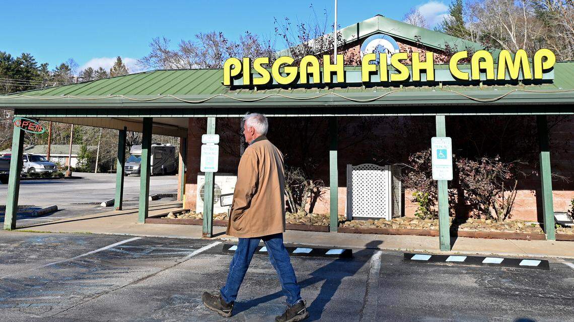 Mike Hawkins walks past the Pisgah Fish Camp Restaurant in Brevard, NC, on Friday, November 15, 2024. The restaurant has been in his family for almost 60 years. Rain from Hurricane Helene filled a creek near the restaurant causing water to rise three feet. With three feet of water inside the restaurant, the walls, wiring, and cooking equipment were damaged. The restaurant remains closed.