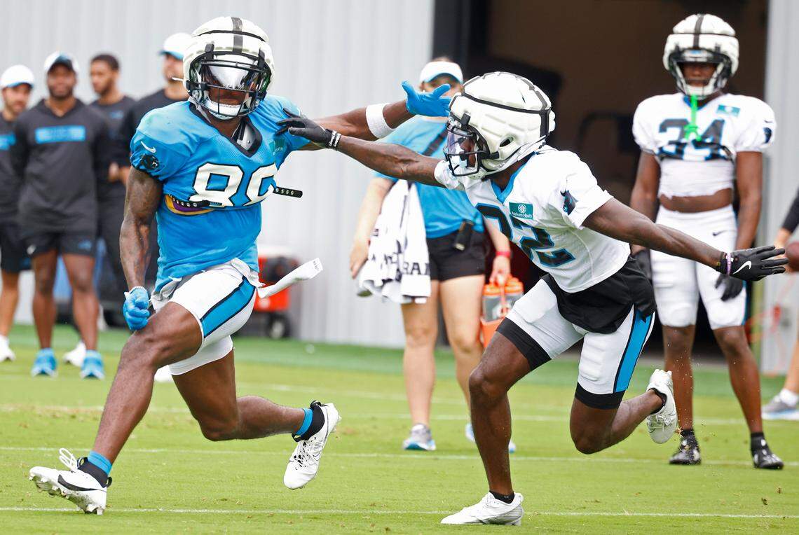 Carolina Panthers wide receiver Terrace Marshall Jr., left, battles cornerback Dicaprio Bootle, right, off the line during practice on Tuesday, August 6, 2024.