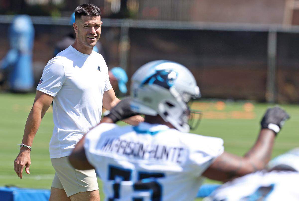 Carolina Panthers head coach Dave Canales walks around the field watching players run through stretching drills during the team’s rookie minicamp practice on May 9, 2025. 