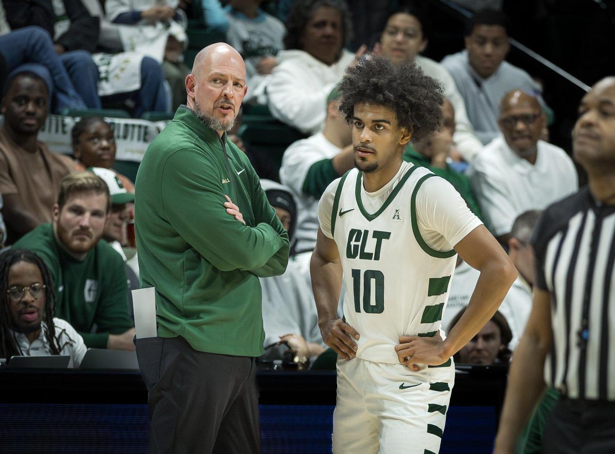 Charlotte Men’s Head Basketball coach Aaron Fearne (left) has a quick meeting with Junior guard Nik Graves (right) during 49er’s free throws. Charlotte would host the Memphis Tigers in an American Athletic Conference game on January 19, 2025.