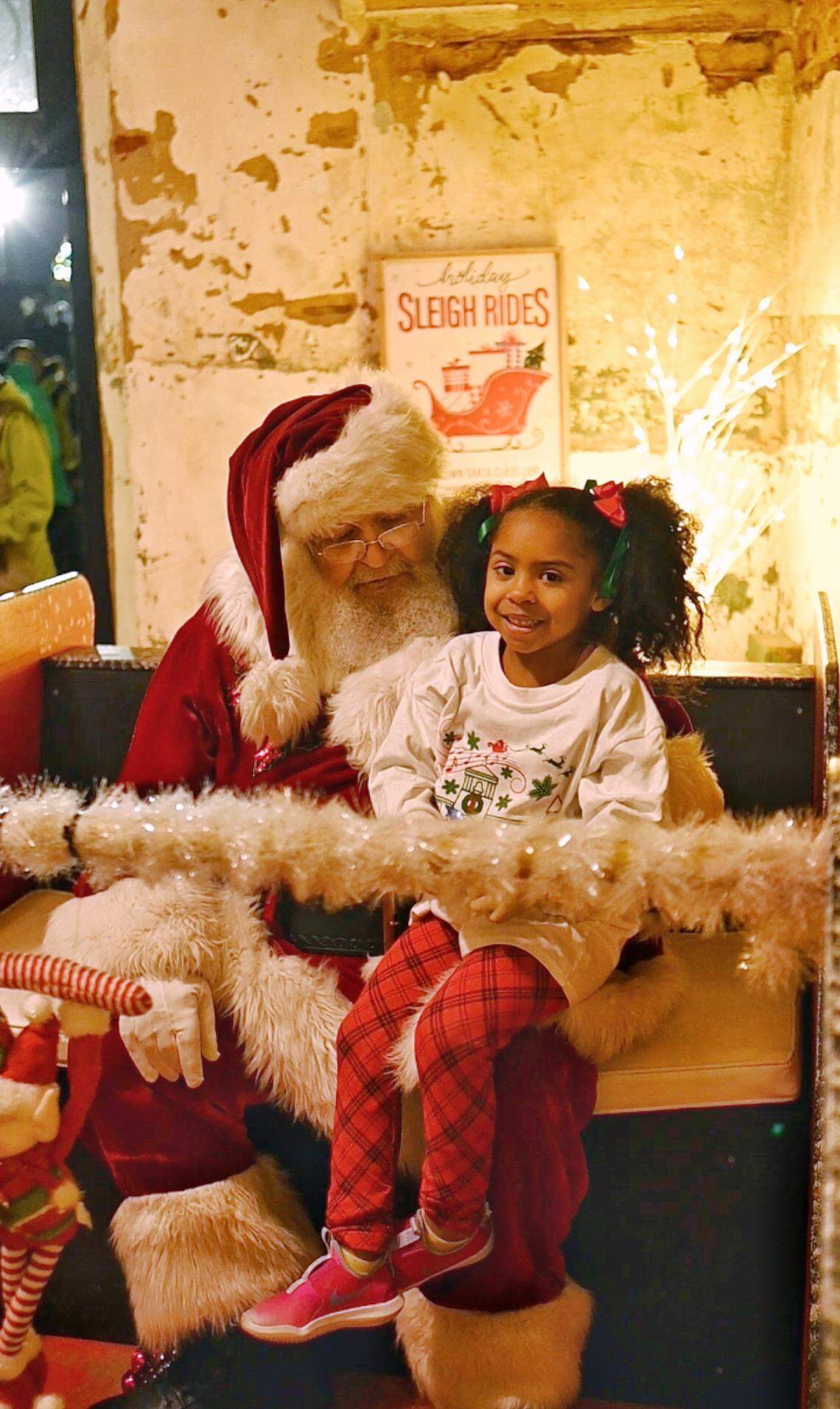 Santa reads a story to a child in McAdenville.