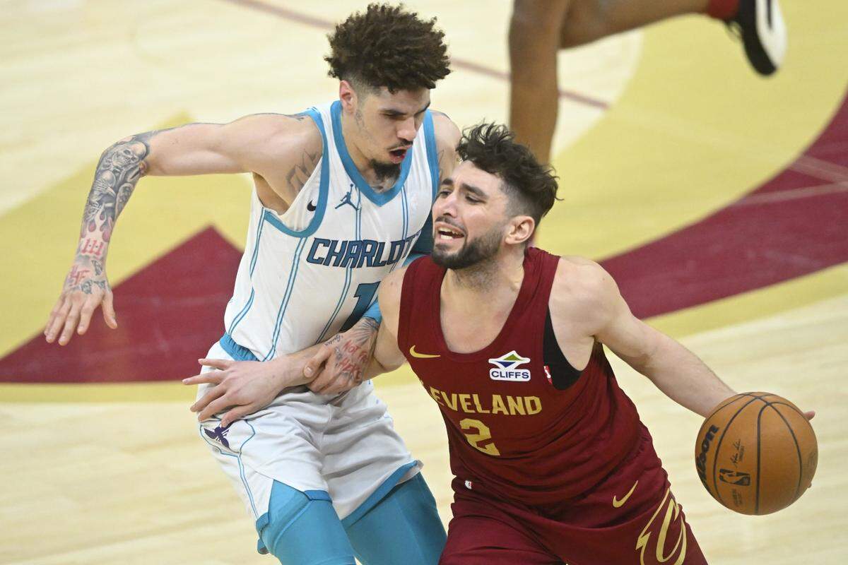 Charlotte Hornets guard LaMelo Ball (1) defends Cleveland Cavaliers guard Ty Jerome (2) in the fourth quarter at Rocket Mortgage FieldHouse.