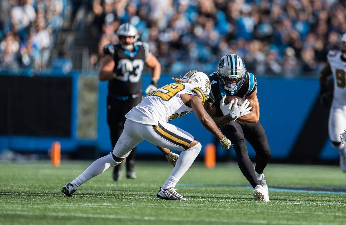 Carolina Panthers wide receiver Tetairoa McMillan(right) collides with New Orleans Saints cornerback Quincy Riley at Bank of America Stadium in Charlotte on Nov. 9th.