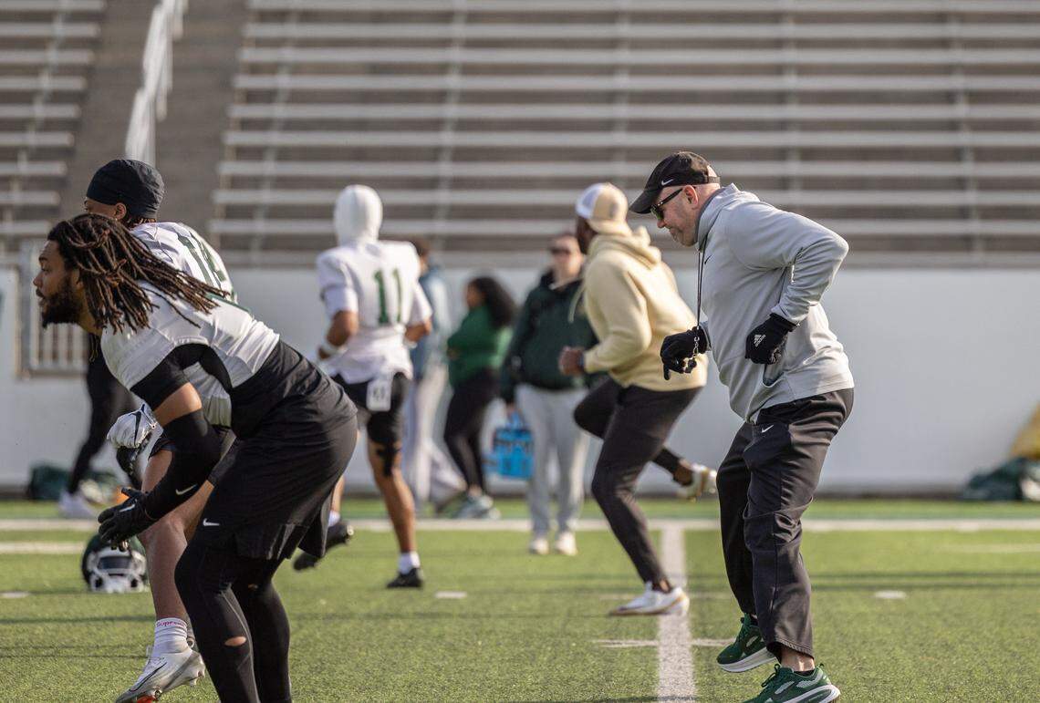 Charlotte 49ers’ Tim Albin warms up with players during spring football practice at Jerry Richardson Stadium on Tuesday, March 24, 2026.