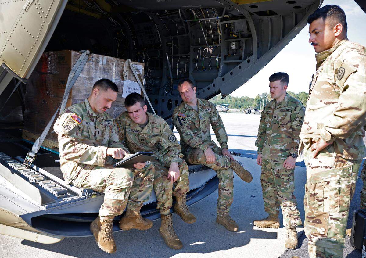 Bravo Company 1-171 pilot in command Karson Smith, left, leads a briefing for members of the crew prior to their departure to Western North Carolina to deliver pallets of bottled water and ready to eat meals on Thursday, October 3, 2024.