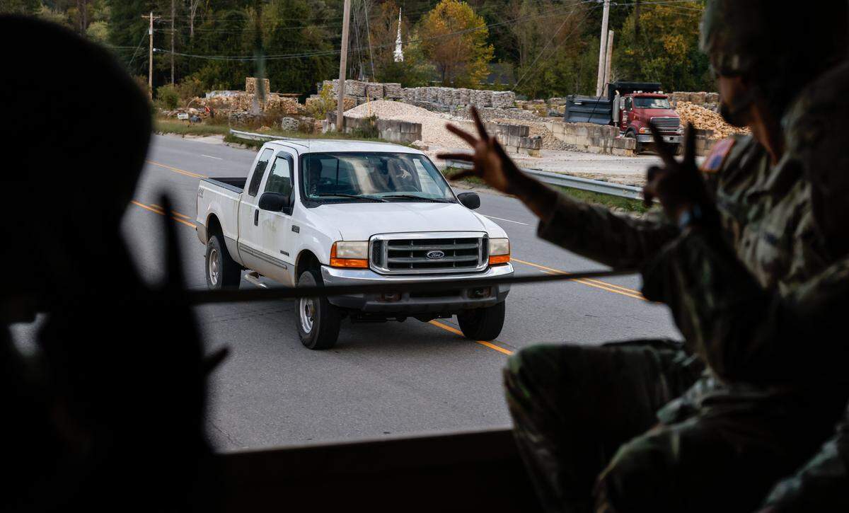 Soldiers wave back to one of many people who waved at them Oct. 9, 2024, on the drive back to Marion after a day helping at distribution sites in Spruce Pine and Bakersville as part of Hurricane Helene recovery relief.