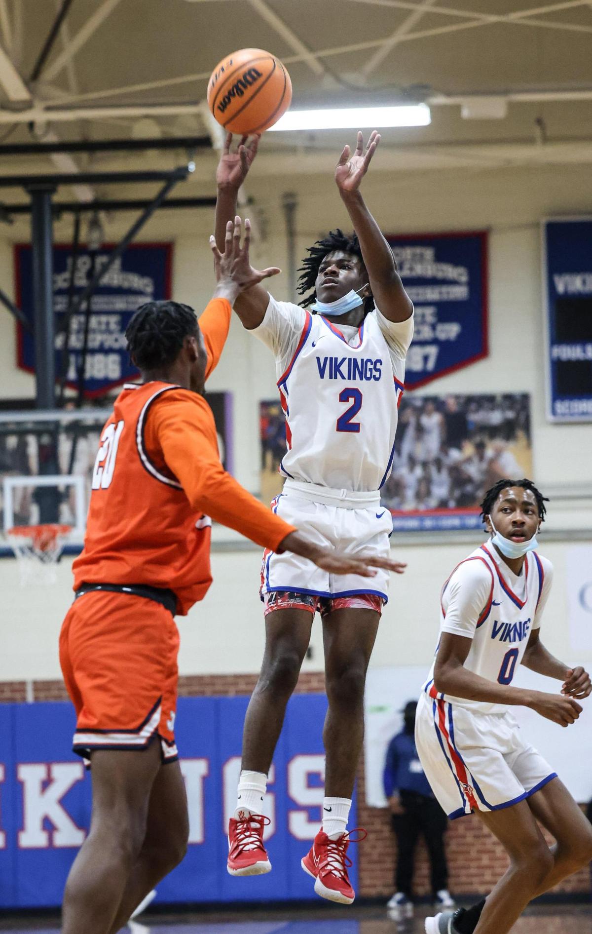 North Mecklenburg’s Jordan Crawford, right, shoots past Chambers’ Maurio Hanson at North Mecklenburg High School in Huntersville, N.C., on Friday, January 7, 2022.