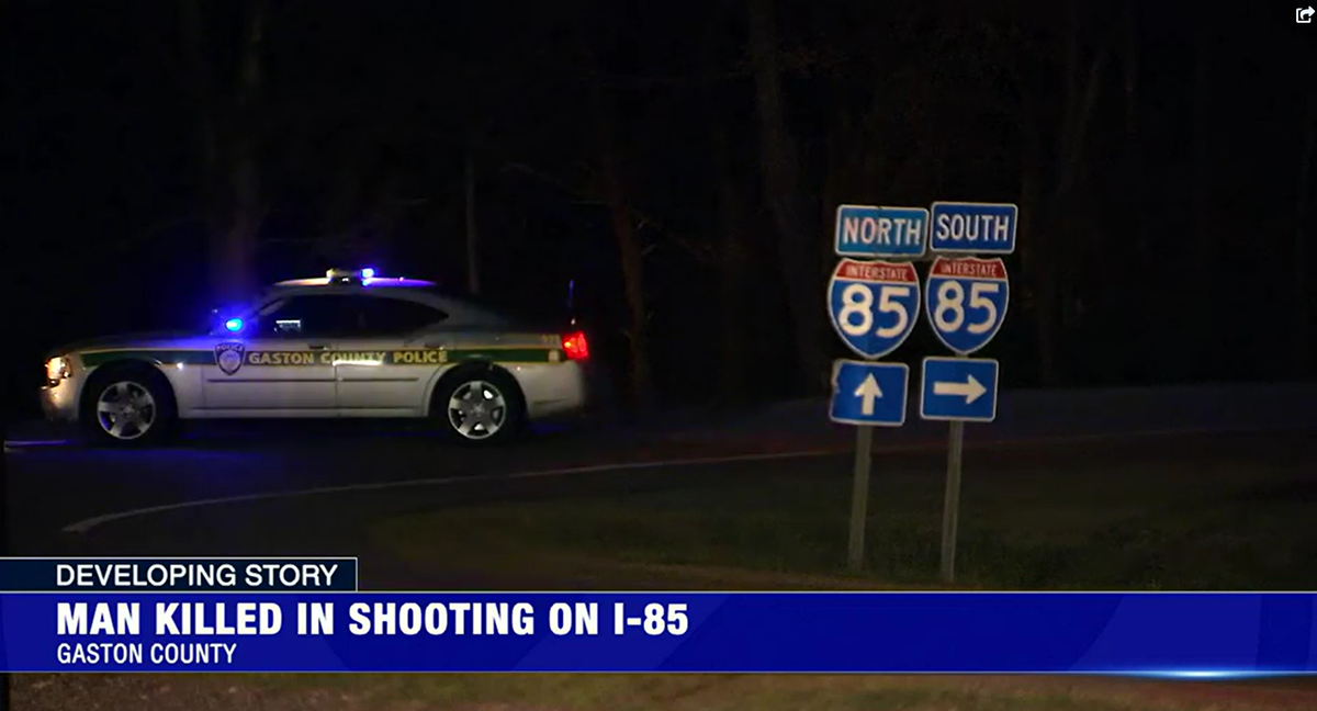 In this screen capture from WSOC-TV video, a Gaston County Police vehicle blocks a road near Interstate 85 following a shooting on the highway on Tuesday, March 22, 2022. Police are searching for a white Dodge Charger in the case.