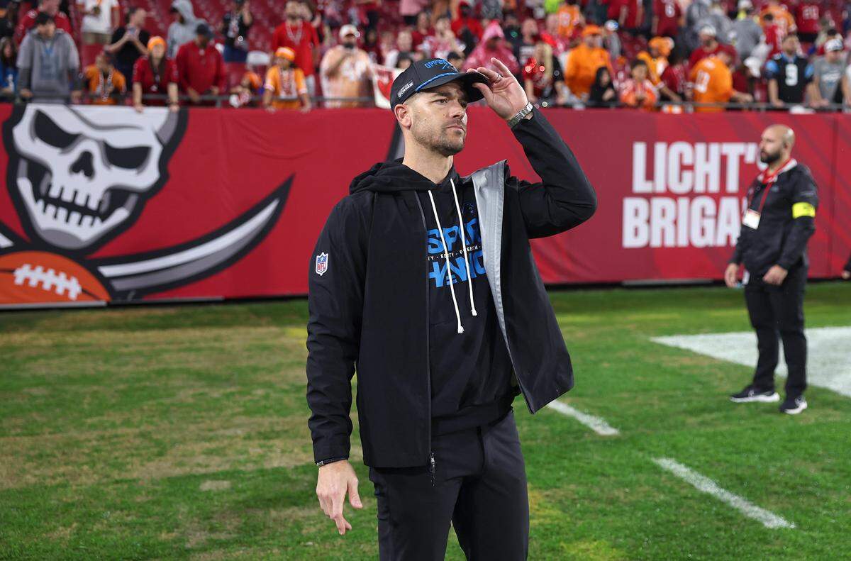 Carolina Panthers head coach Dave Canales waits along a sideline to embrace his players following the team’s 16-14 loss to the Tampa Bay Buccaneers at Raymond James Stadium in Tampa, FL.on Saturday, January 3, 2026. 