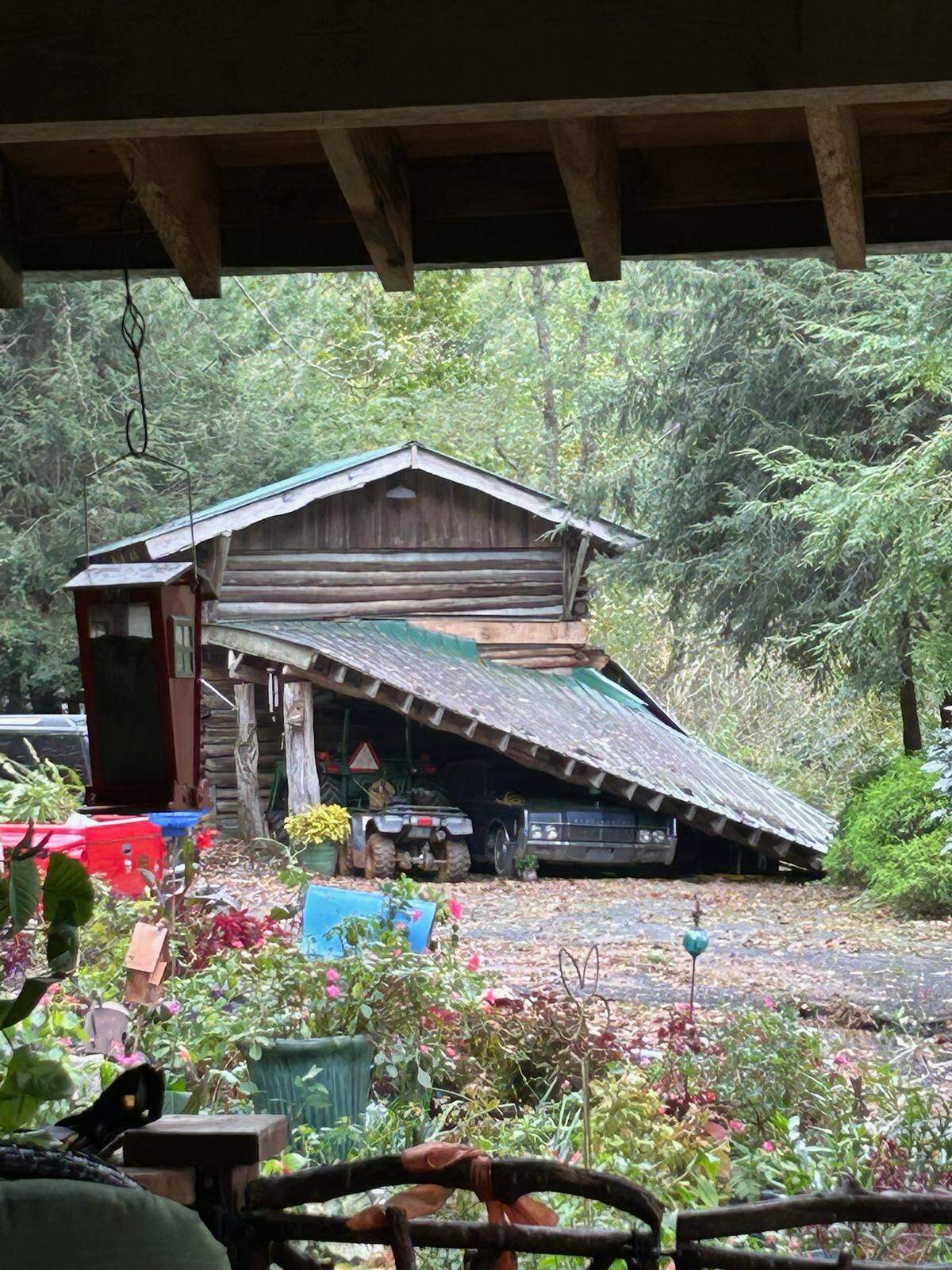 The roof collapse of John and Jeannette Bledsoe’s tobacco shed blocked their tractor and a car, and destroyed their generator.