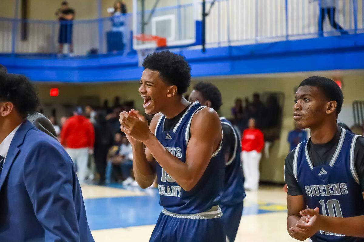 Queen’s Grant’s Jamal Mustaf cheers from the sidelines, celebrating with excitement as his team secures a hard-fought win over Victory Christian