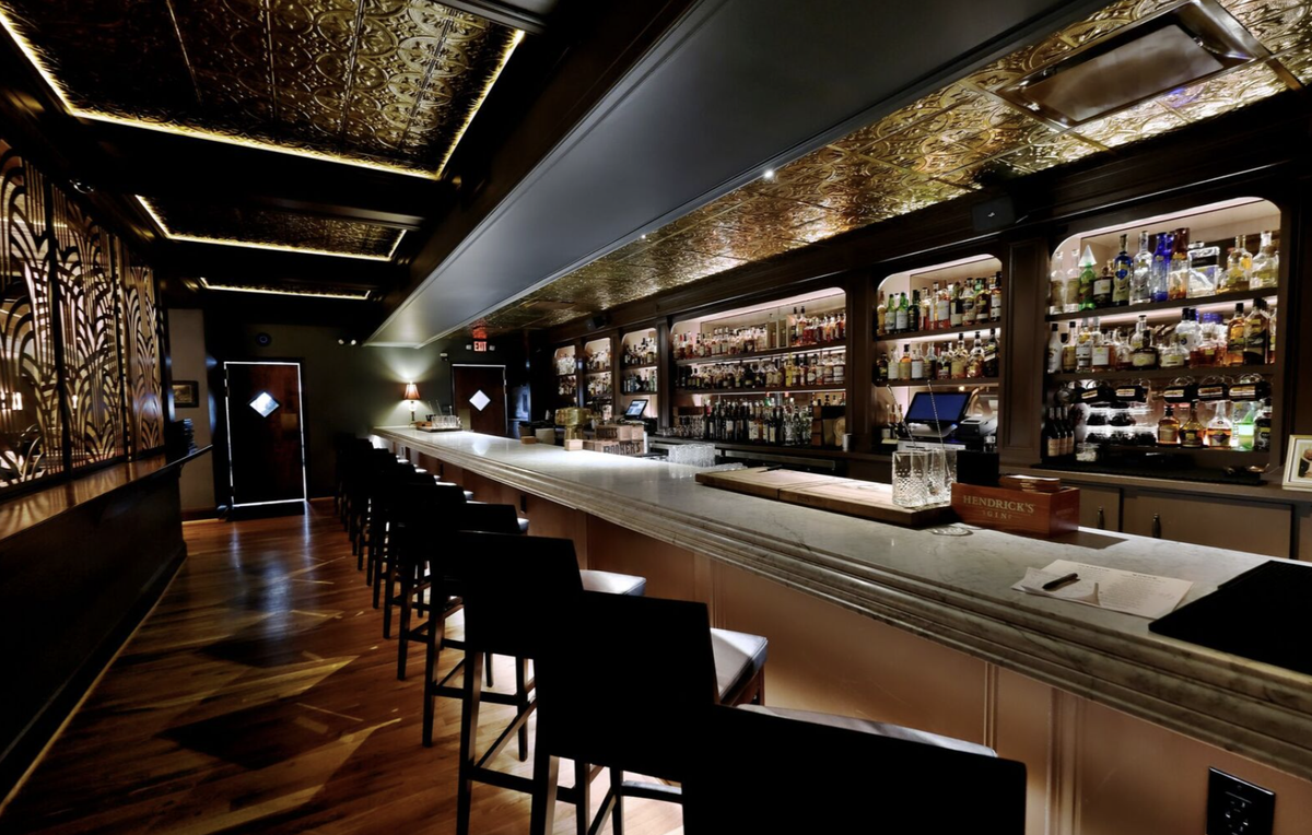 Dot Dot Dot is a fancy bar in Park Road shopping center, with red leather and moody lighting, to capture speakeasy charm.