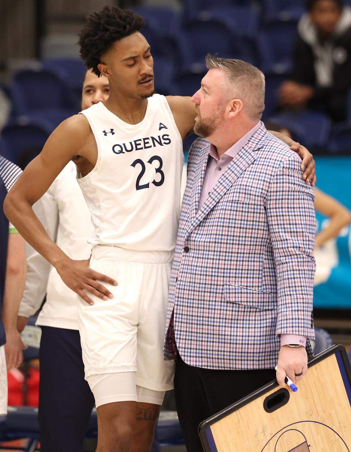 Queens University of Charlotte head coach Grant Leonard, right, talks with forward Leo Colimerio, left, during a break in the action against the North Florida Ospreys on Thursday, January 23, 2025 at Curry Arena in Charlotte, NC. North Florida defeated Queens 90-81, despite Colimerio’s 22 points.