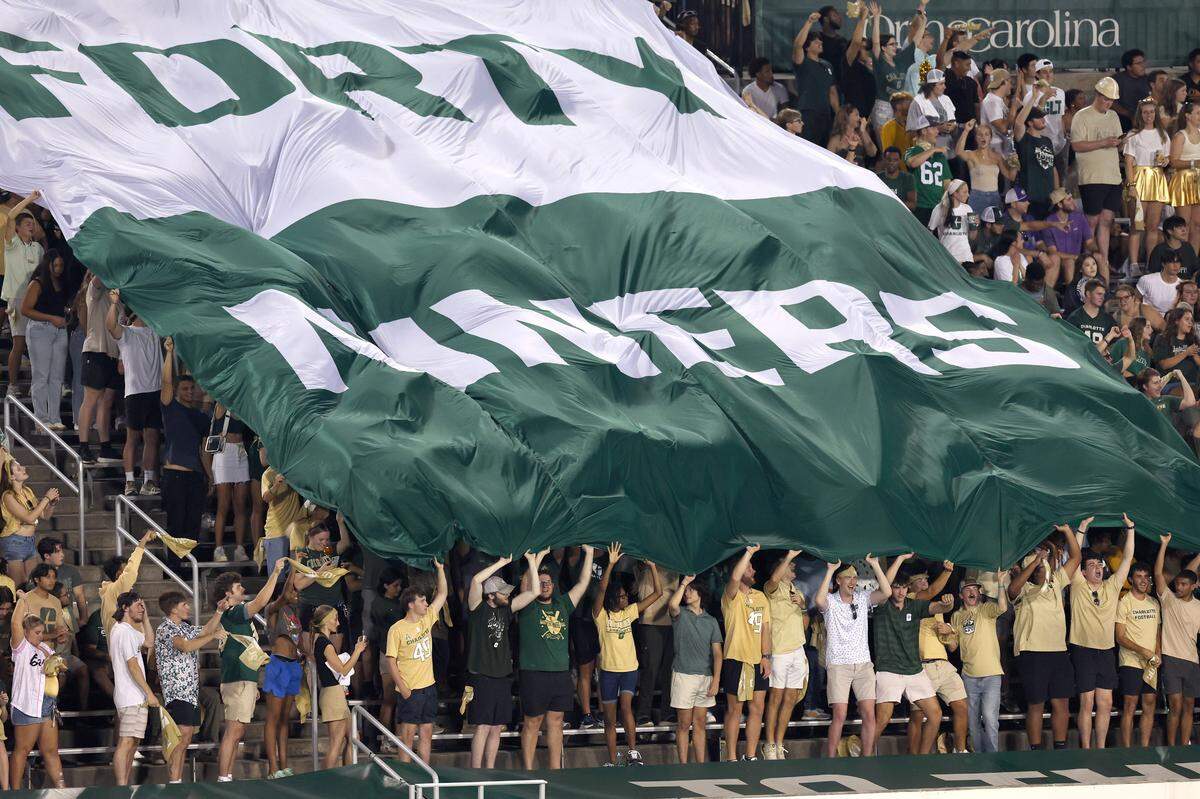 Charlotte 49ers fans cheer on the team against James Madison. The 49ers’ opening game at Jerry Richardson Stadium drew a sellout crowd of 15,614.