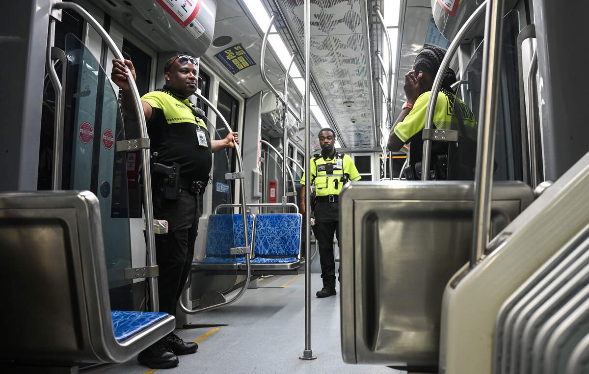 Security officers ride the light rail after checking for valid tickets from passengers in Charlotte on Thursday, August 20, 2026. Despite the fatal stabbing of Iryna Zarutska last year, many light rail riders have not decreased their use of the local transportation system. While some riders have said they rarely get checked for their light rail pass, they have also noticed an increase in the presence of security guards and CMPD officers.