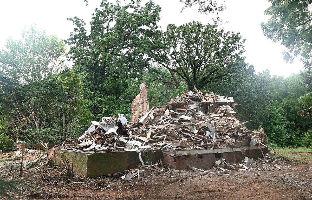 The former Steele Creek Presbyterian Manse sits in a pile of rubble after being demolished along Steele Creek Road in Charlotte, NC.