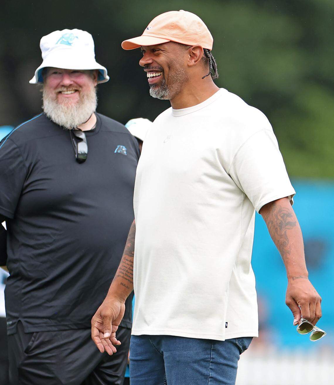 Former Carolina Panthers defensive end and NFL Hall of Fame member Julius Peppers speaks with personnel along the sideline as he watches the team practice on Tuesday, August 6, 2024.