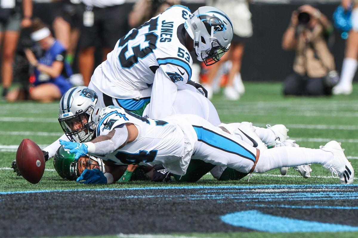 Panthers linebacker Kamu Grugier-Hillduring, rcenter, reaches for the loose ball after tackling Jets wide reciever Malik Taylor during the pre-season game at Bank of America Stadium on Saturday, August 12, 2023 in Charlotte, NC.