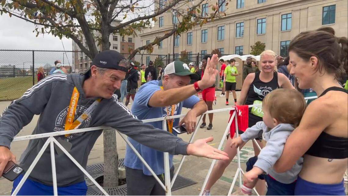 Erin Del Giudice, right, celebrates winning the Novant Health Charlotte Marathon in November 2022 with her daughter Emma and assorted running friends.