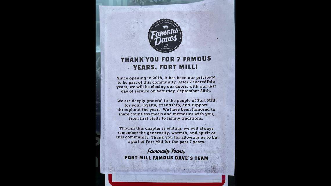 A faded paper notice posted on a window with the Famous Dave’s logo at the top announces the closing of the Fort Mill location. The text states the restaurant is closing its doors after seven years of service.