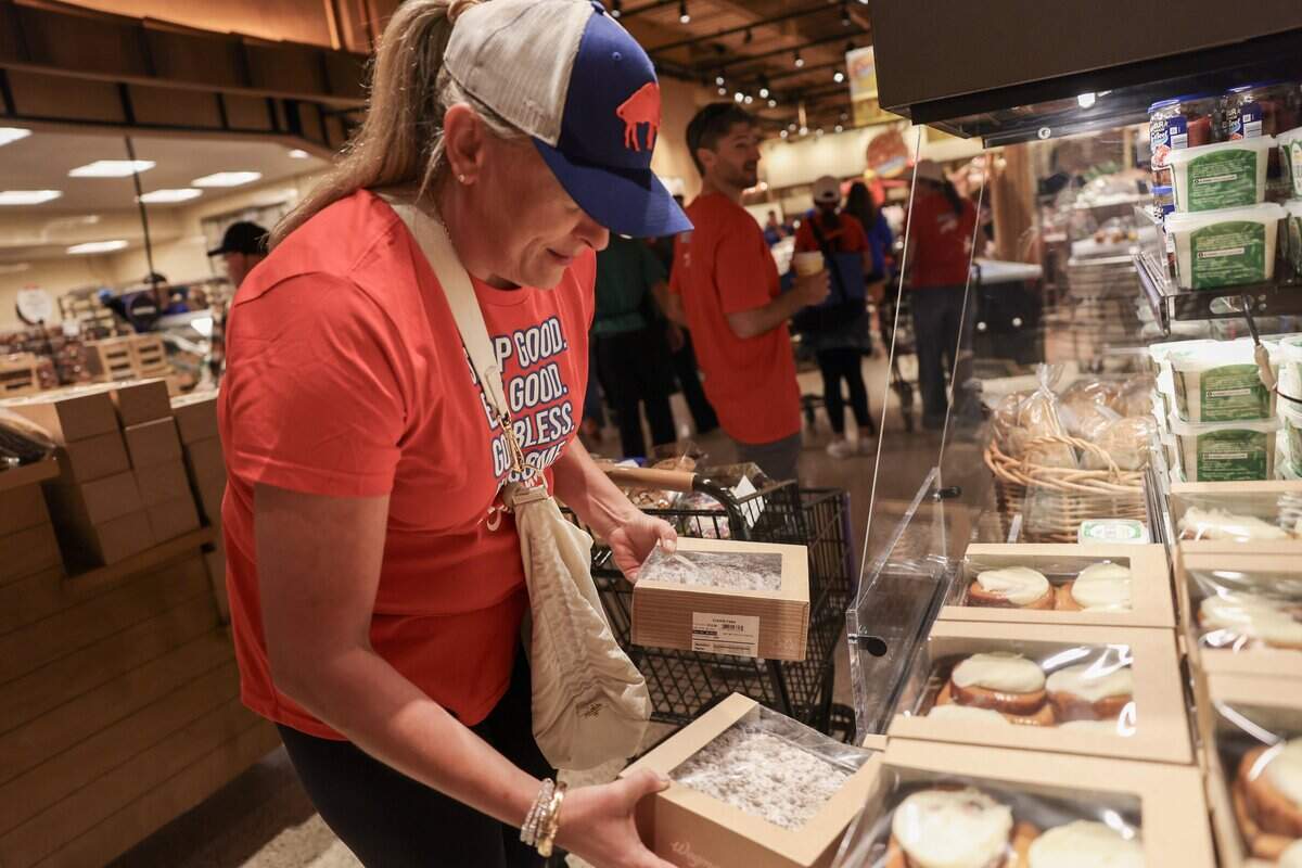 A Buffalo Bills fan checks out some pastries during a shopping trip to Wegmans in Charlotte on Wednesday, Oct. 14, 2026.
