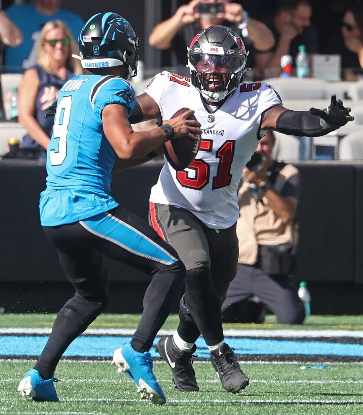 Carolina Panthers quarterback Bryce Young, left, is rushed by Tampa Bay Buccaneers linebacker David Walker, right, during action at Bank of America Stadium in Charlotte, NC on Sunday, October 25, 2026.