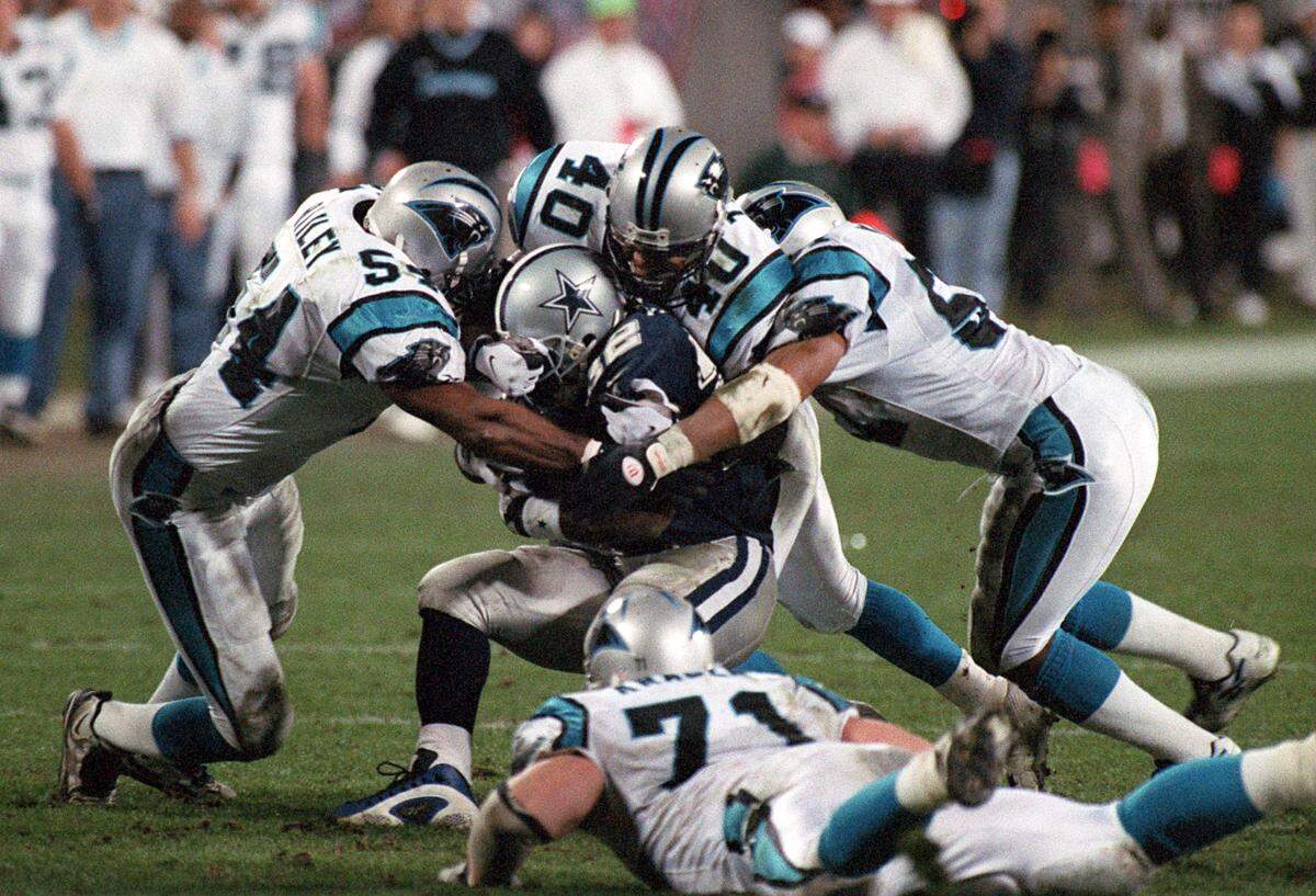 Dallas running back Emmitt Smith is swarmed by the Panthers’ defense during Carolina’s first playoff win on Jan. 6, 1997.
