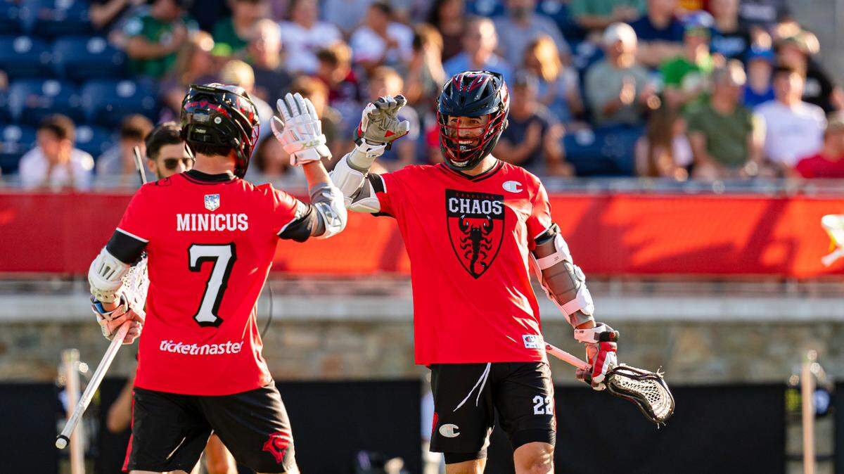 Carolina Chaos attackmen Josh Byrne, right, and Brian Minicus, left, celebrate during their 12-11 victory in the Premier Lacrosse League’s showcase in Charlotte, N.C., on June 7, 2024.