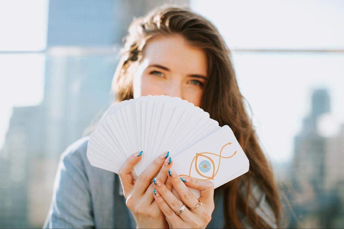 Professional tarot reader Mariah Oller fans her custom-made tarot deck, named The Tarot of Life.