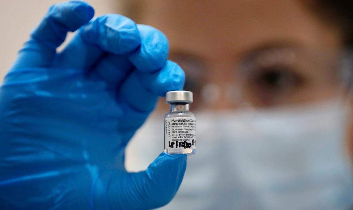 A nurse holds a phial of the Pfizer-BioNTech COVID-19 vaccine at Guy’s Hospital in London, Tuesday, Dec. 8, 2020. As N.C. hospitals prepare to receive COVID-19 vaccines, a new poll shows that only 40% of North Carolinian respondents said they would get an FDA-approved vaccine to fight the virus.
