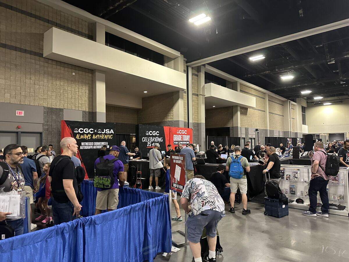 HeroesCon attendees at the Certified Grading Company booths in the back corner of the Charlotte Convention Center get their comic books graded for preservation and fortune on Friday.