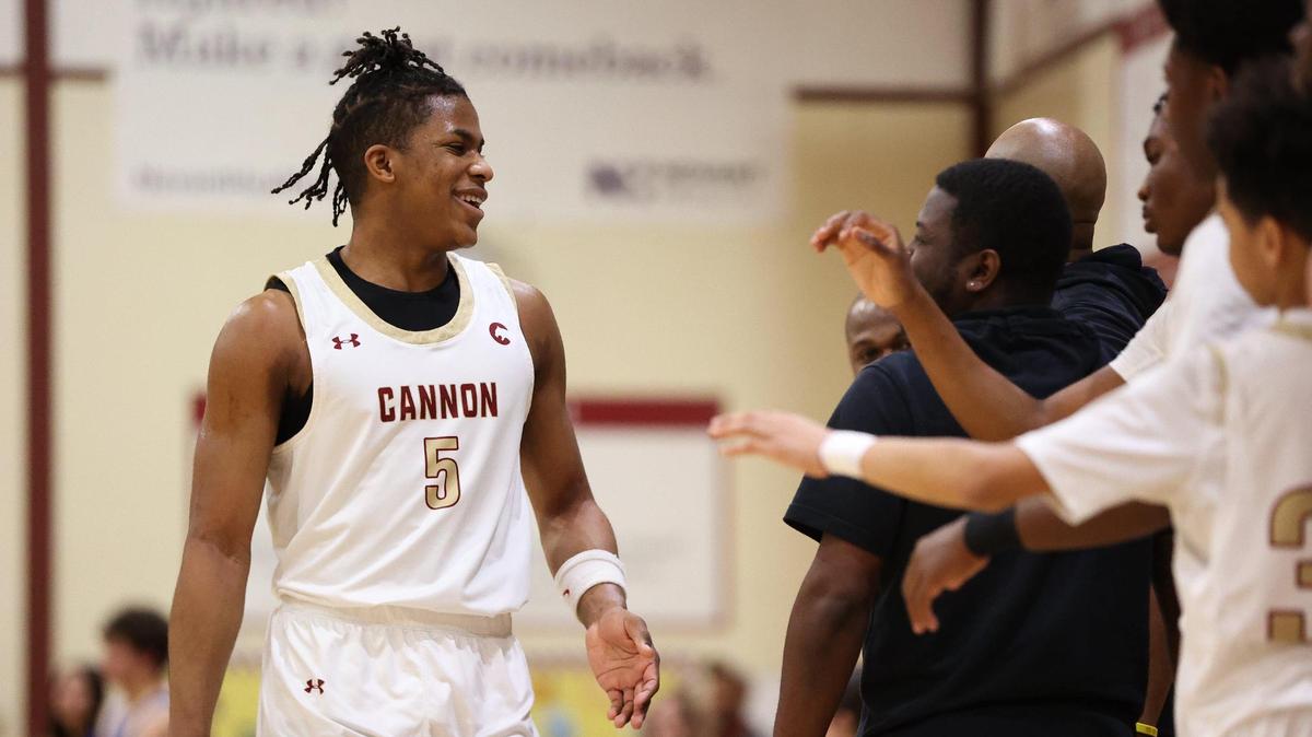 CONCORD, NC - FEBRUARY 17: Cannon School junior forward Isaiah Henry (5) smiles as he heads to the bench against the Cary Academy in the NCISAA State semifinals at Cannon School on February 17, 2024.