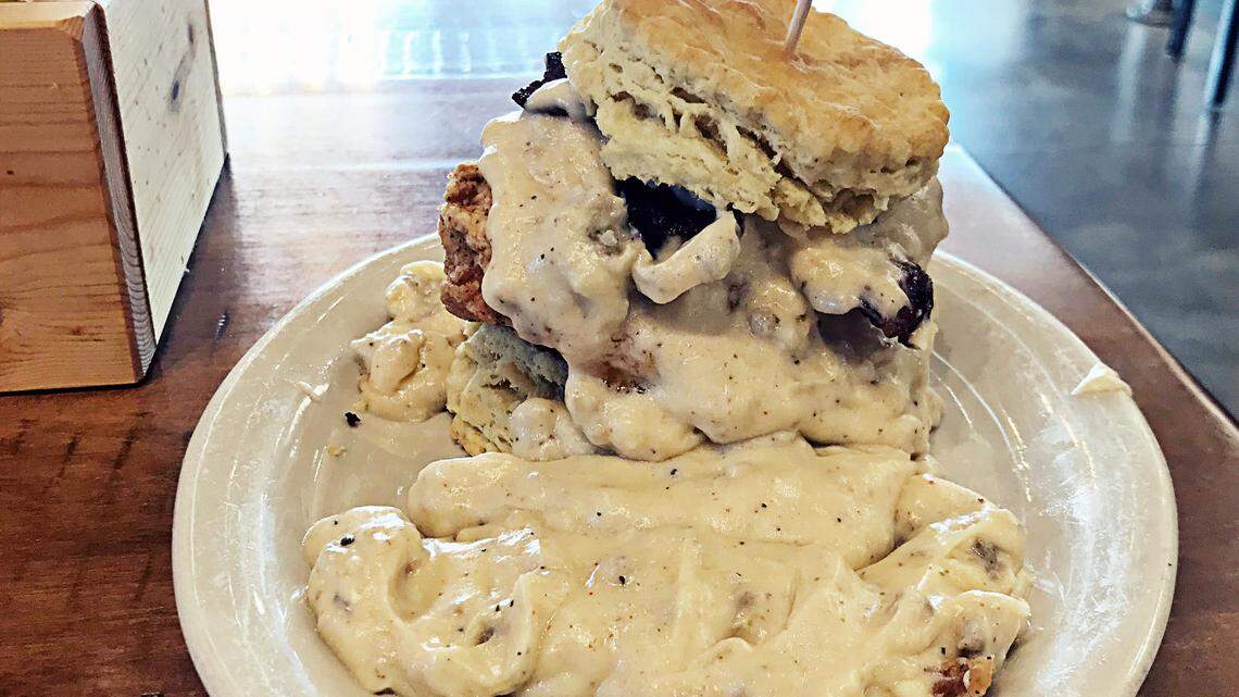 The Five from Maple Street Biscuit Company is a fried chicken breast biscuit sandwich that includes smoked bacon and cheddar cheese and is topped with sausage gravy.