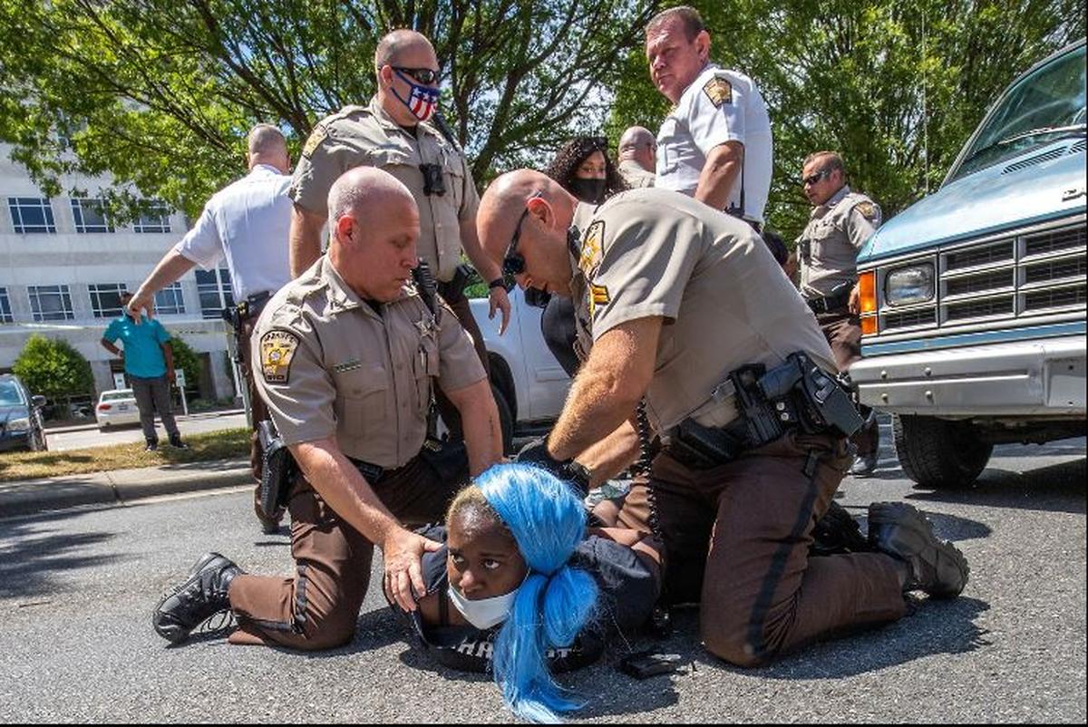 The Gaston County manager ordered this photograph of sheriff’s deputies arresting a protester at a Confederate monument in downtown Gastonia pulled from a photography exhibit at the Gaston County Museum, according to a county statement and the photographer, Grant Baldwin.