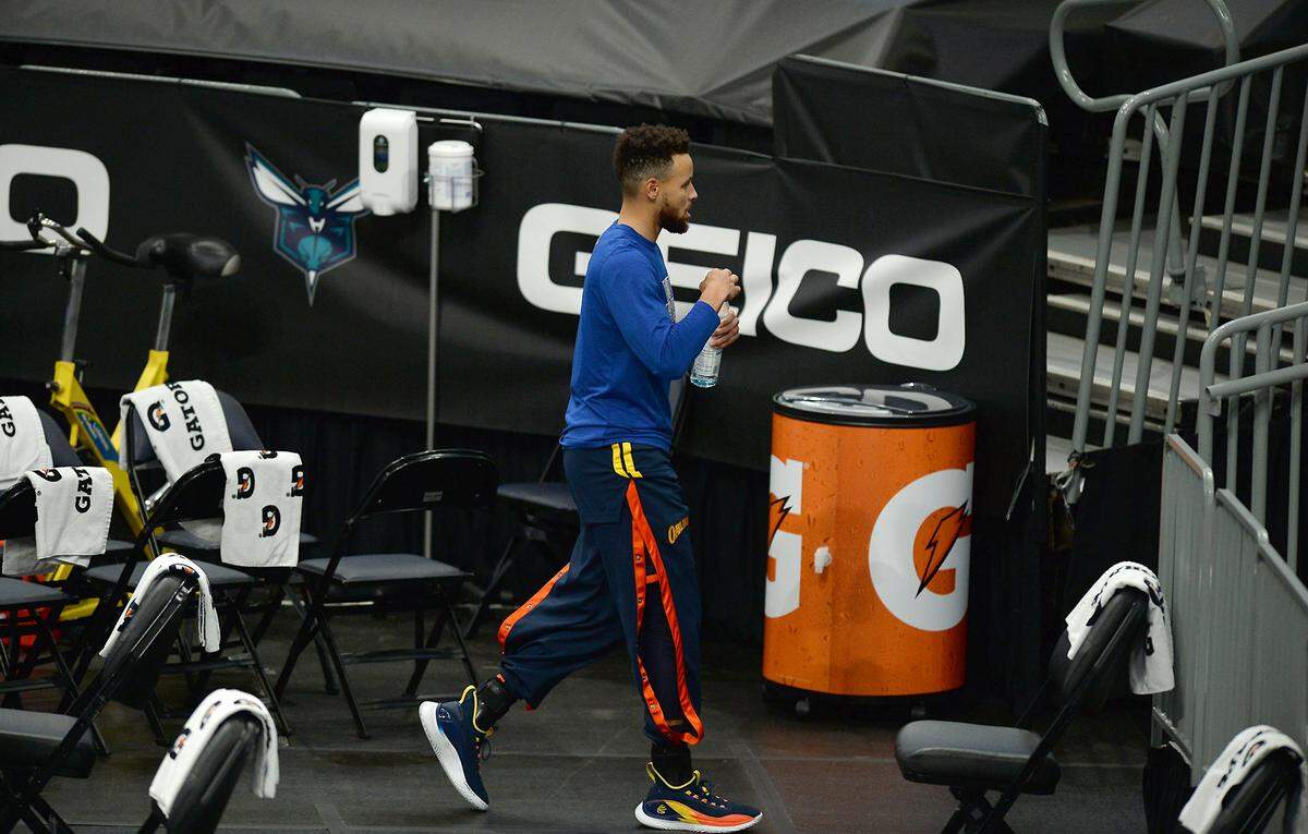 Golden State Warriors guard Steph Curry exits the floor after warming up prior to the team’s game against the Charlotte Hornets at Spectrum Center in Charlotte, NC on Saturday, February 20, 2021. Curry became ill prior to tip-off and did not play.