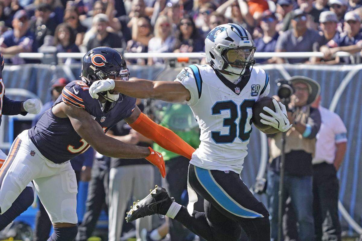Oct 6, 2024; Chicago, Illinois, USA; Carolina Panthers running back Chuba Hubbard (30) runs for a touchdown against the Chicago Bears during the first half at Soldier Field. Mandatory Credit: David Banks-Imagn Images