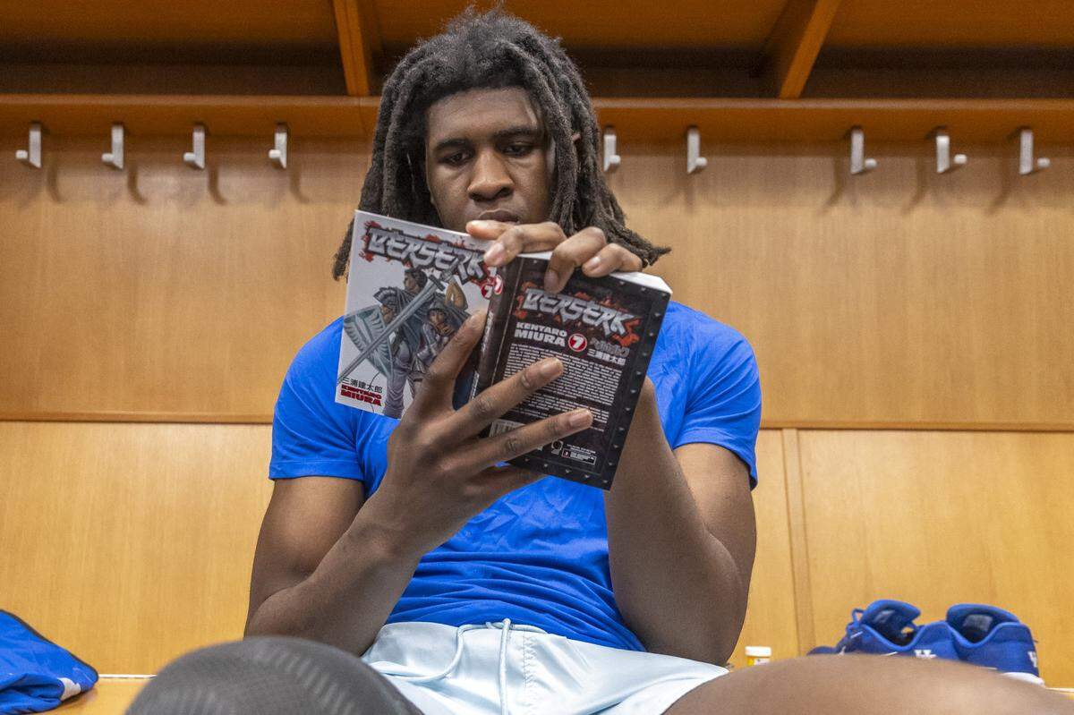 Kentucky Wildcats forward Jayden Quaintance (21) reads a book during an open locker room at Enterprise Center in St. Louis. 