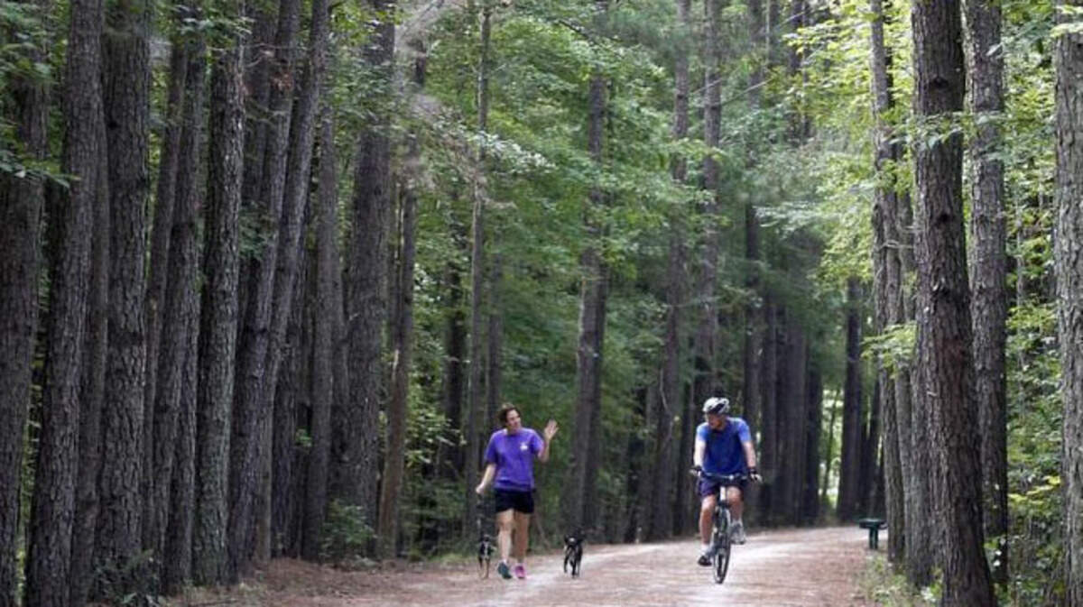 In this 2014 file photo, Rachel Davis, left, of Holly Springs, talks with Jim Metz of Cary while on the American Tobacco Trail near the White Oak Church Road Access area in Apex, N.C.