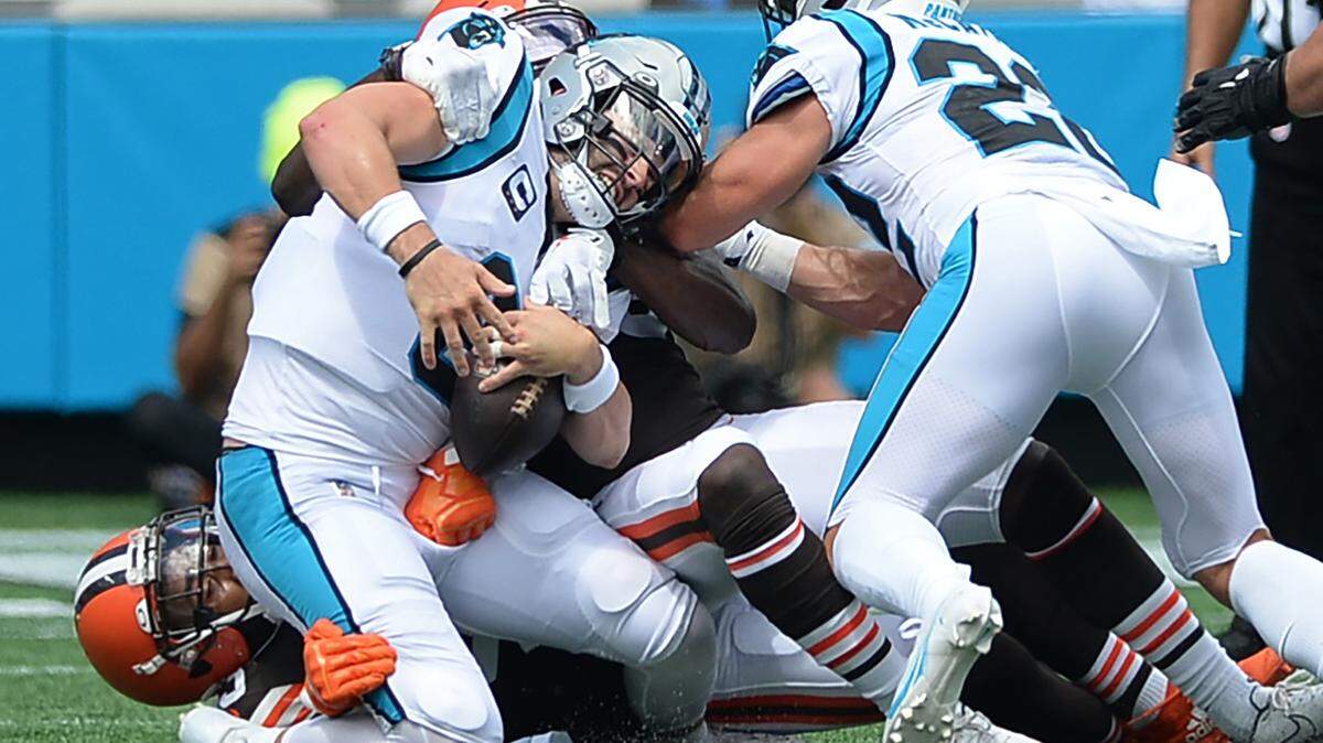 Carolina Panthers quarterback Baker Mayfield is sacked by Cleveland Browns safety John Johnson III during late first quarter action at Bank of America Stadium on Sunday, September 11, 2022.